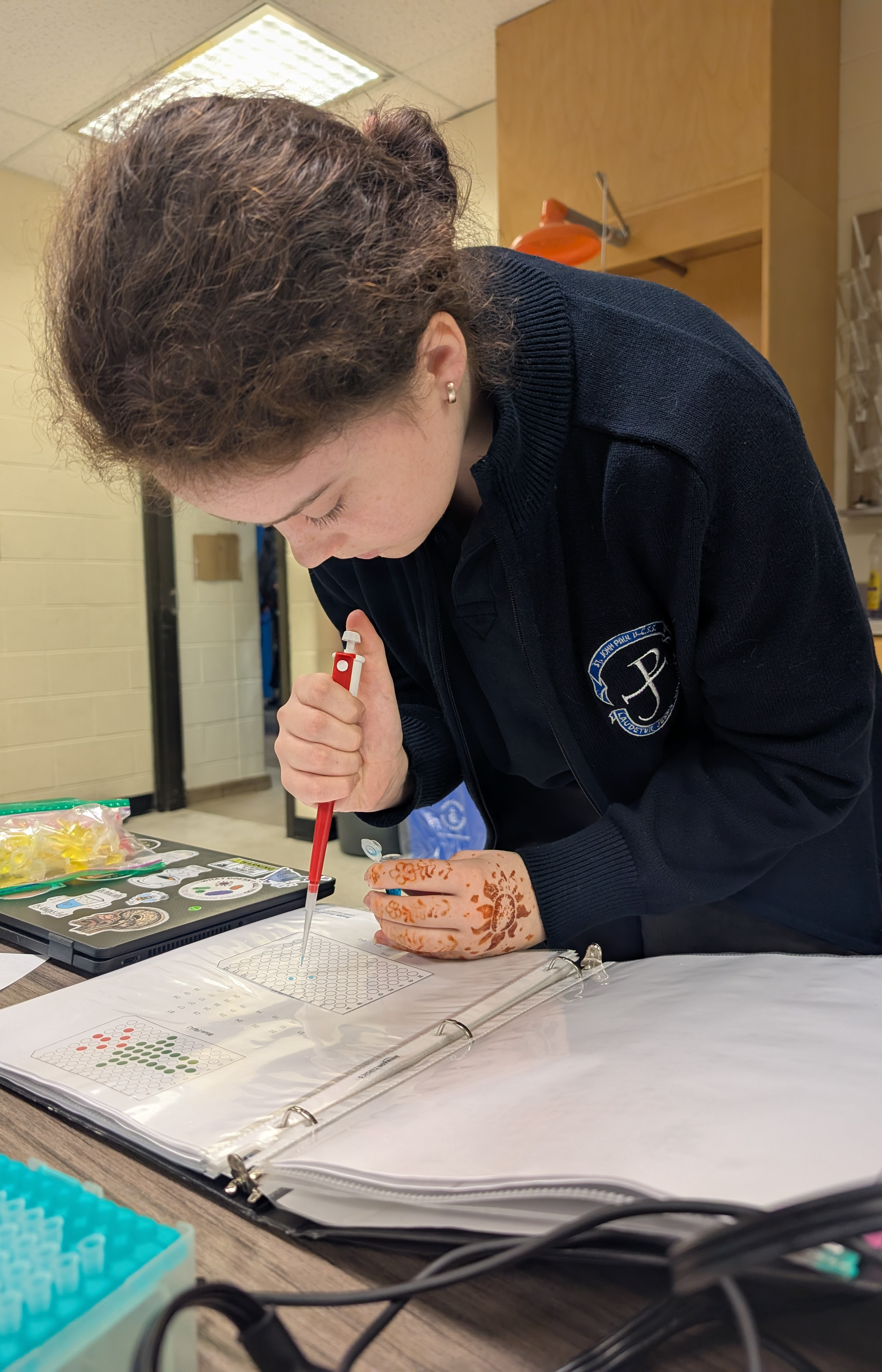 student working with a micropipette