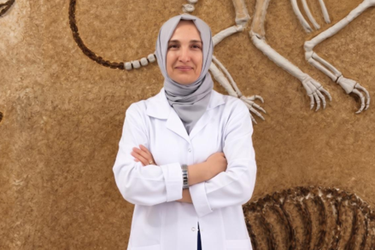 Woman in white lab coat facing the camera