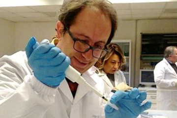 Male teacher working with micropipette