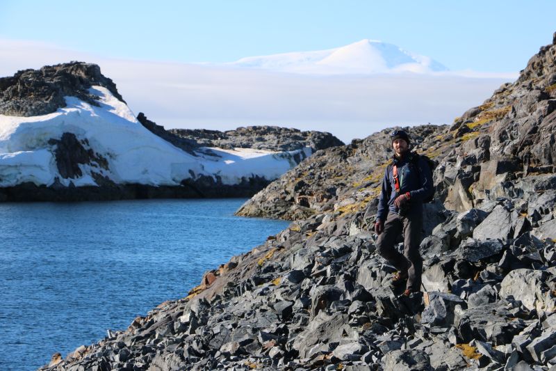 Draw Spacht standing on a rocky coastline in Antarctica