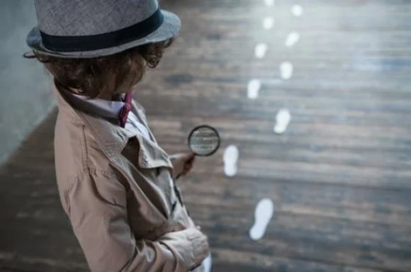 female detective looking at suspicious footprints