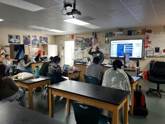 Amgen staff person speaking in front of students about his career