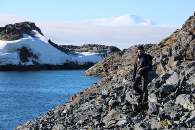 Draw Spacht standing on a rocky coastline in Antarctica